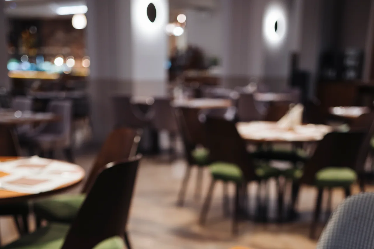 An empty restaurant dining room with set tables